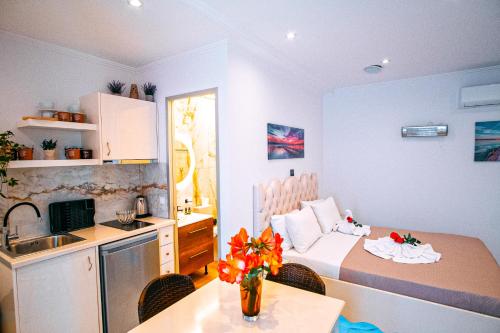 a kitchen and a bedroom with a bed and a table at Valtos View in Parga
