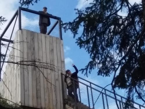 two men standing on top of a wooden wall at Chalupa Novák in Semily