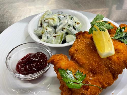 a plate of food with chicken tenders and a salad at Eggerwirt Kitzbühel, Hotel & Restaurant in Kitzbühel