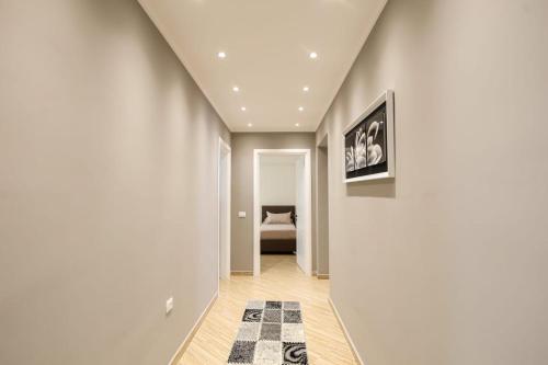 a hallway with a room with a bed and a rug at Valbona Apartament's 2 in Vlorë