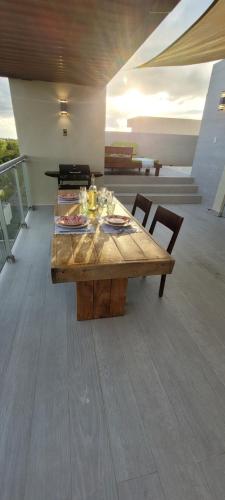 a wooden table with two chairs on a balcony at Vibe Residence Gorgeous Penthouse with Jacuzzi & outstanding Sea & Natural Preserve view in La Laguna