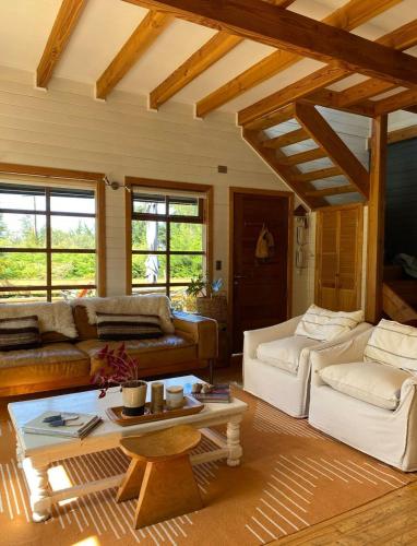 a living room with couches and a coffee table at Lofts Magnolias in Puerto Varas