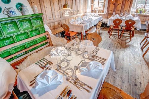 a dining room with white tables and chairs at Ropferhof in Telfs-Buchen