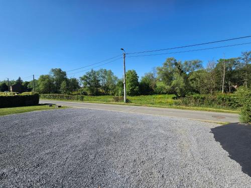an empty road with a telephone pole on the side at La Villa Fer D'art in Houyet