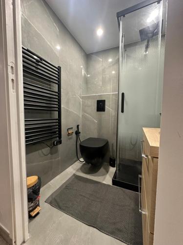 La salle de bains est pourvue d'une douche et d'une baignoire noire. dans l'établissement Appt nice 5 min de la mer, à Nice
