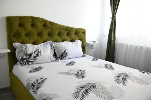 a bed with black and white sheets and pillows at Evo Moonlight by the sea in Mamaia