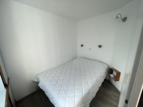 - une petite chambre avec un lit blanc dans l'établissement Résidence Port Bourgenay - maeva Home - Appartement 2 Pièces 5 Personnes - Prestige MAE-5164, à Talmont-Saint-Hilaire