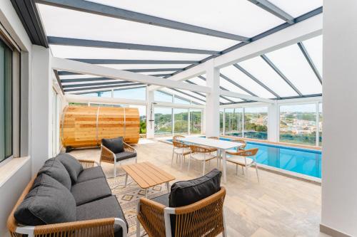a living room with a couch and chairs and a table at Villa Moinhos da Costa in Foz do Arelho