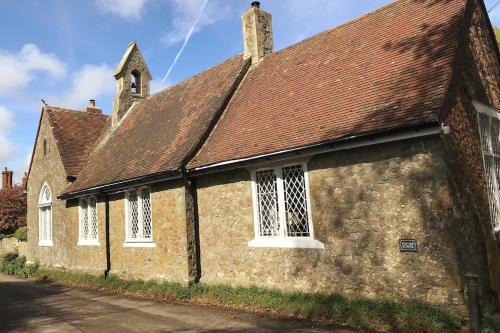 an old stone church with a brown roof at The Old School in Seabrook
