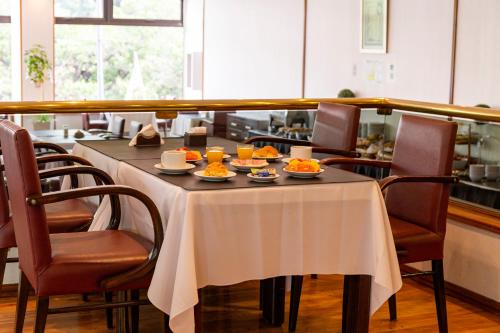 a table with plates of food on top of it at Hotel Conte in Buenos Aires