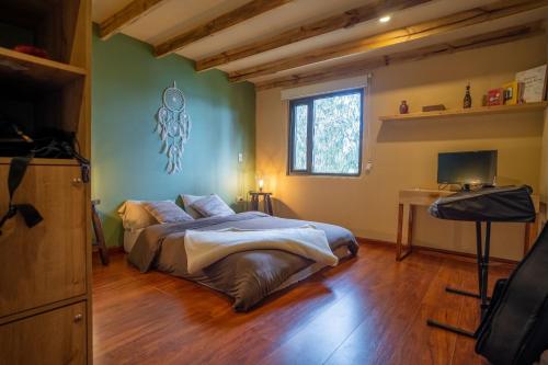 a bedroom with a bed and a television in it at La Quinta Glamping - Lago de Tota in Cuítiva