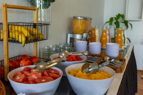 a bunch of bowls of fruit on a counter at Hotel Conte in Buenos Aires