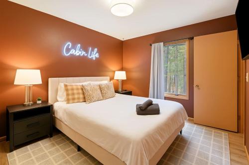 a bedroom with a large bed with a sign on the wall at Mountain Mojo Luxe Cabin Vibes in McGaheysville