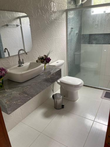 a bathroom with a sink and a toilet and a shower at My House Muriqui in Mangaratiba