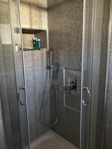 a shower with a glass door in a bathroom at Charming Town House, Limani 9 in Mirina
