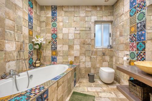 a bathroom with a tub and a toilet and a sink at Brand New apartment in central Msida by SF HOMES in Misraħ Il-Barrieri