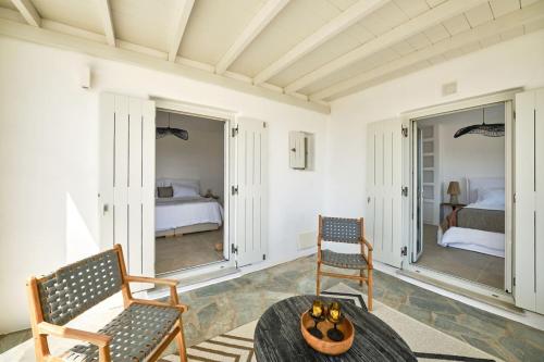 a living room with two chairs and a table at Villa Inke - Secluded Luxury in Kóstos
