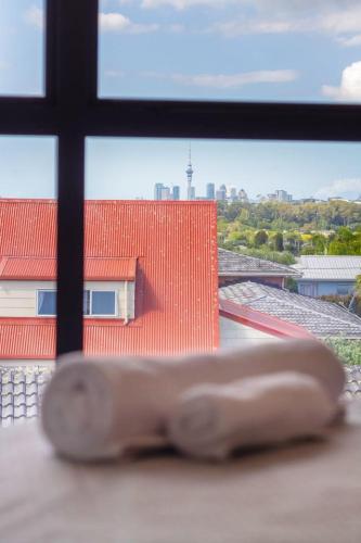 a view of a red building from a window at Stunning Mount Albert 2 Bed in Auckland