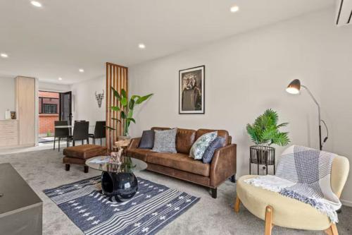 a living room with a couch and a table at Comfortable Family Home in Auckland