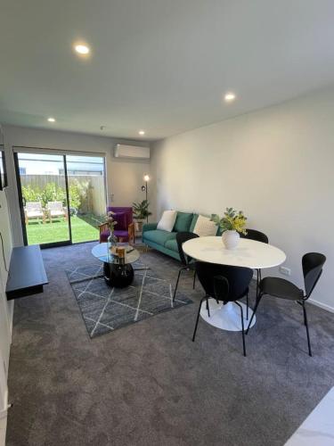a living room with a couch and a table at Well-furnished Auckland Stunner in Auckland