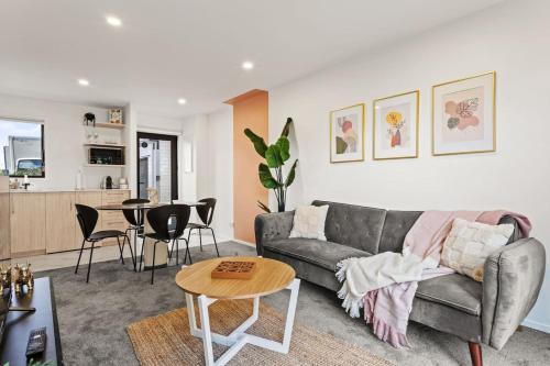 a living room with a couch and a table at Charming 2 Bed Family Home in Auckland