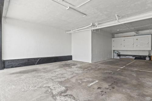 an empty room with a room with a bench in it at Penthouse Steps from Victoria Beach 180 degree ocean views in Laguna Beach