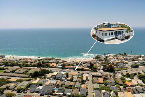 a house in a sphere flying over a city at Ocean VIEWS Steps from Victoria Beach Lux Design in Laguna Beach