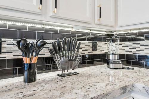 a kitchen counter with a bunch of kitchen utensils at Avengers HQ - Hot Tub - Close to Disney - Parking in Anaheim