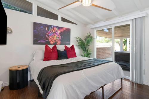 a bedroom with a large bed with red pillows at Avengers HQ - Hot Tub - Close to Disney - Parking in Anaheim