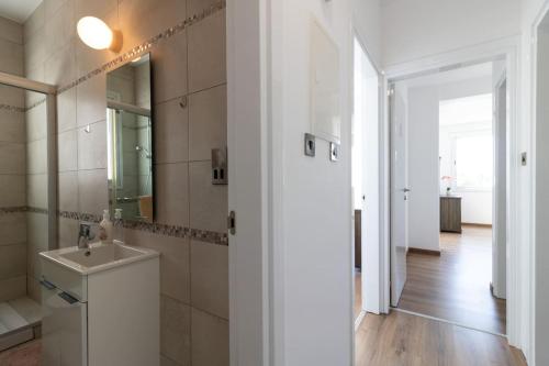 a bathroom with a sink and a mirror at Villa Orchid - Luxury 3BR Retreat between Paphos & Coral Bay in Kissonerga