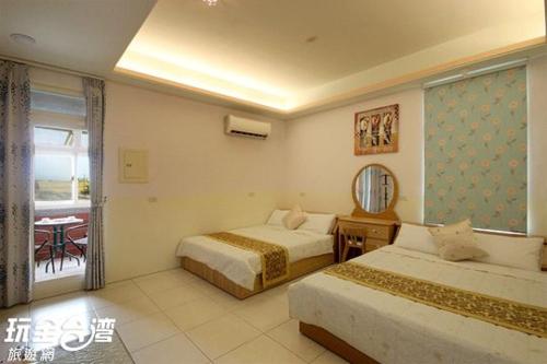 A bed or beds in a room at Xinchuan B&B