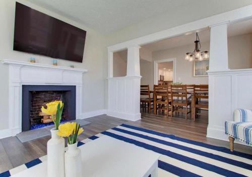 a living room with a fireplace and a dining room at Sleeps 16 Large Groups 2 Full Homes In Vermilion in Vermilion