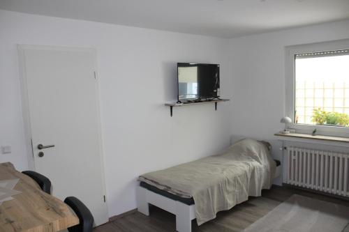 a bedroom with a bed and a tv on the wall at FeWo Ruhrgebiet Rombergskamp in Gelsenkirchen
