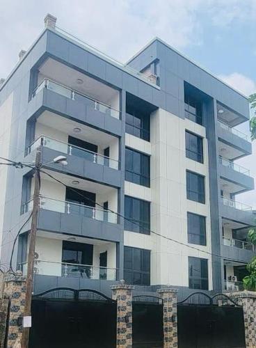 a tall building with a lot of windows at Cité la vie in Douala
