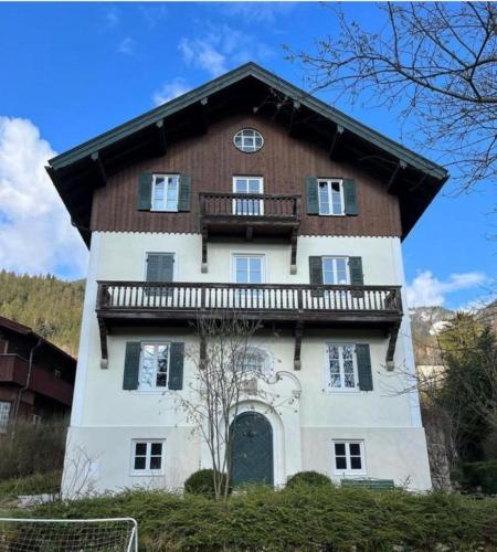 a large house with a balcony on top of it at Haus am Bach in Fischbachau