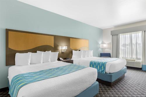 a hotel room with two beds and a window at Best Western Plus Waller Hotel in Waller