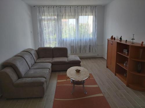 a living room with a couch and a coffee table at Ancsi-Lak Tapolca in Tapolca