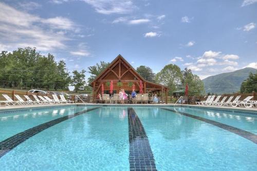 a large swimming pool with chairs and a building at Whiskey Mountain by Avada Properties in Sevierville