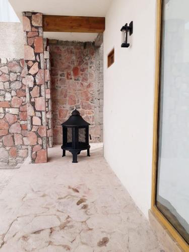 an empty hallway with a brick wall and a fireplace at El Callejón PLATA in Real de Catorce