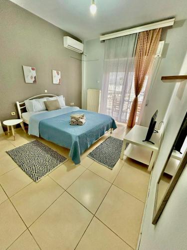 a bedroom with a bed and a table and a window at Cozy apartment 3 in Serres