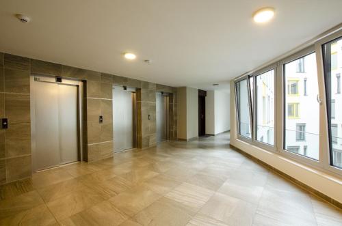 ein leeres Zimmer mit einem großen Fenster und einem Flur in der Unterkunft Harmony106 in Prag