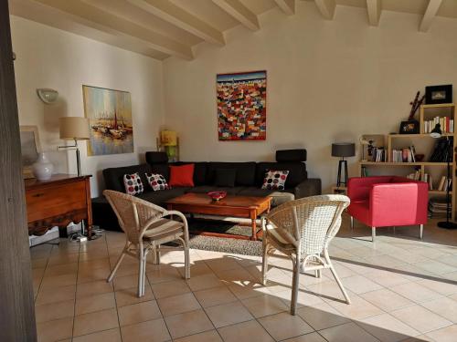 un salon avec un canapé, une table et des chaises dans l'établissement Maison avec 4 Chambres à Saint-Martin-de-Ré, à Saint-Martin-de-Ré