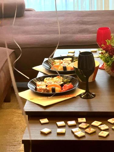 a table with two trays of food on it at Art Lux apartman in Kruševac