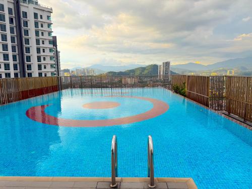 a large blue swimming pool on top of a building at 3 Towers Jalan Ampang By Serenity Vacation Homes in Kuala Lumpur