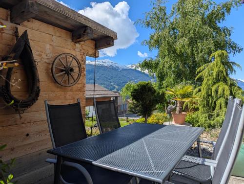 a table and chairs on the patio of a house at Casa Acazia in Brigels