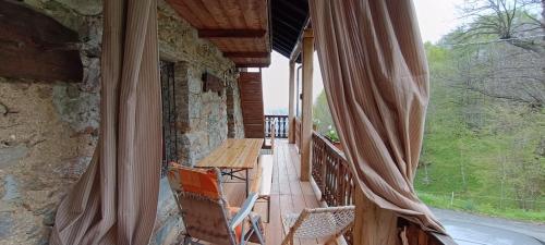 a porch of a house with a table and chairs at Baita Marianna - Relax in Quincinetto in Quincinetto