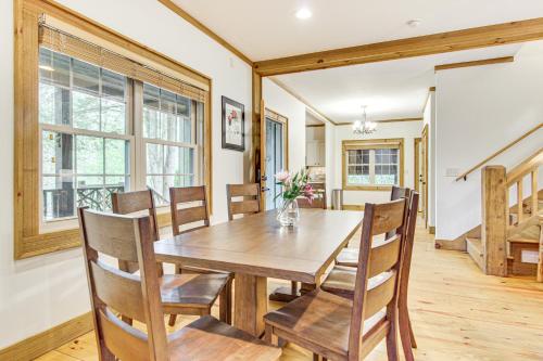 a dining room with a wooden table and chairs at 1 Mi to Downtown Cashiers Private Cabin with Deck in Cashiers