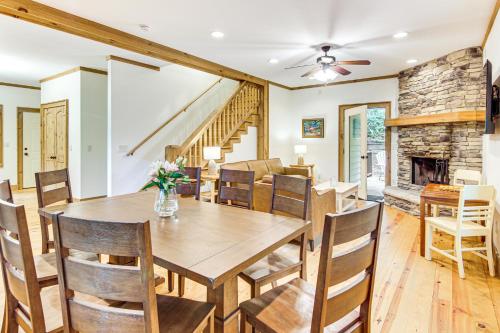 a dining room with a table and chairs and a fireplace at 1 Mi to Downtown Cashiers Private Cabin with Deck in Cashiers