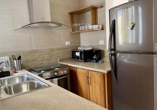 a kitchen with a stainless steel refrigerator and a sink at Casa La Maria Zona Colonial in Santo Domingo