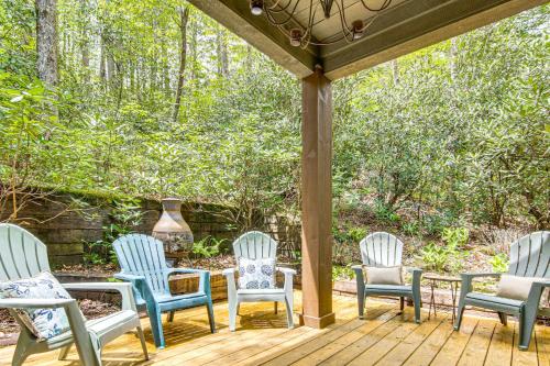 four chairs and a table on a wooden deck at 1 Mi to Downtown Cashiers Private Cabin with Deck in Cashiers